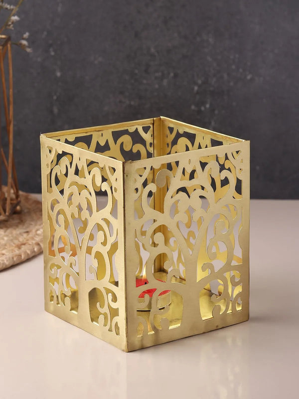Handcrafted brass t-light holder with pierced cut-outs and a warm golden finish