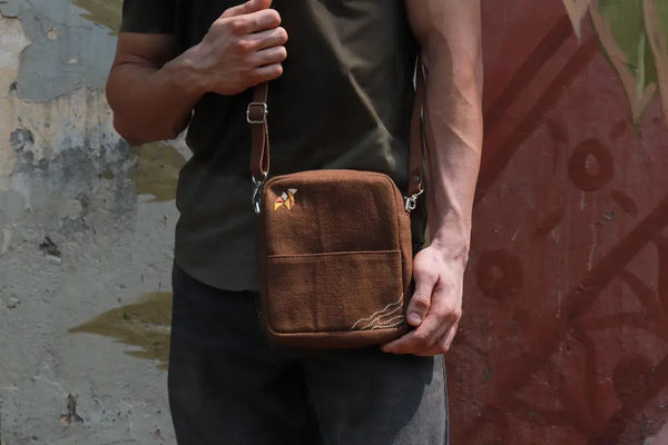 Brown cotton sling bag with an adjustable fabric strap and zip closure, handmade in India