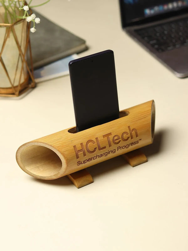 Cylindrical bamboo amplifier with carved phone slot in natural finish