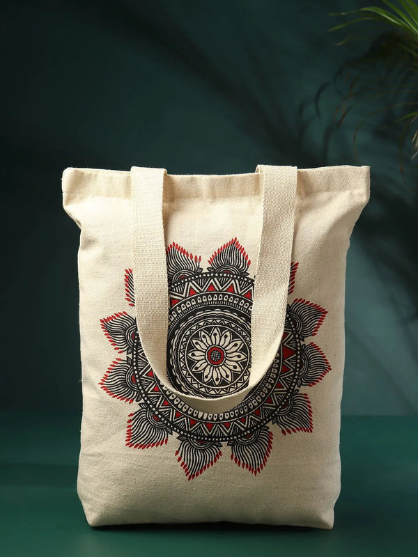 Hand-painted Madhubani mandala on a cotton jhola bag with concentric colour-blocked rings and line-work, Mithila Bihar