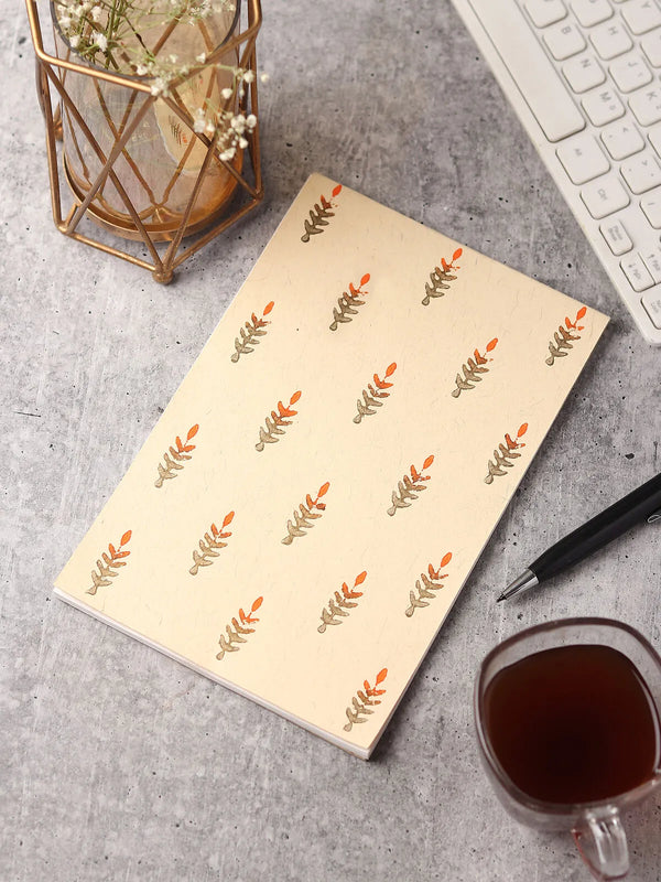 Handcrafted note pad shown closed on a plain surface, front cover facing up