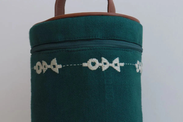 Round handcrafted cloth lunch bag with top handle, neutral fabric, ready to carry a tiffin