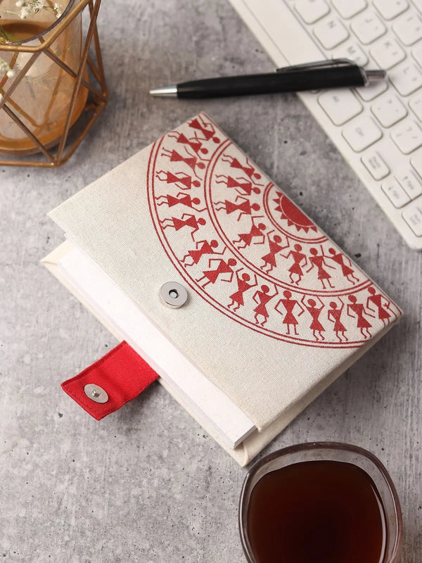 Warli art diary cover with white folk-art figures on a dark earth-toned background, Maharashtra craft