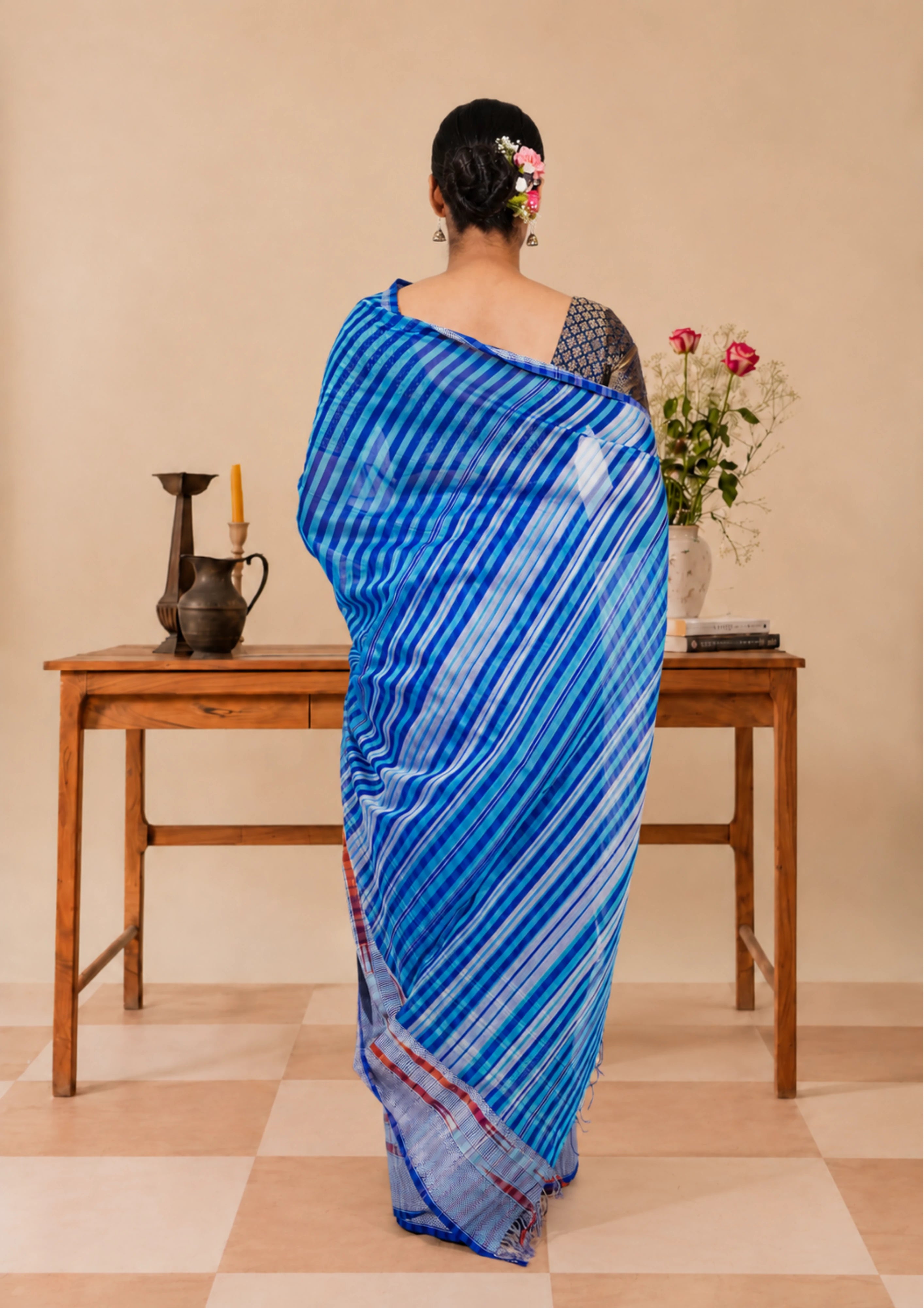 Azure blue striped Maheshwari saree with a silver-toned border, full drape view