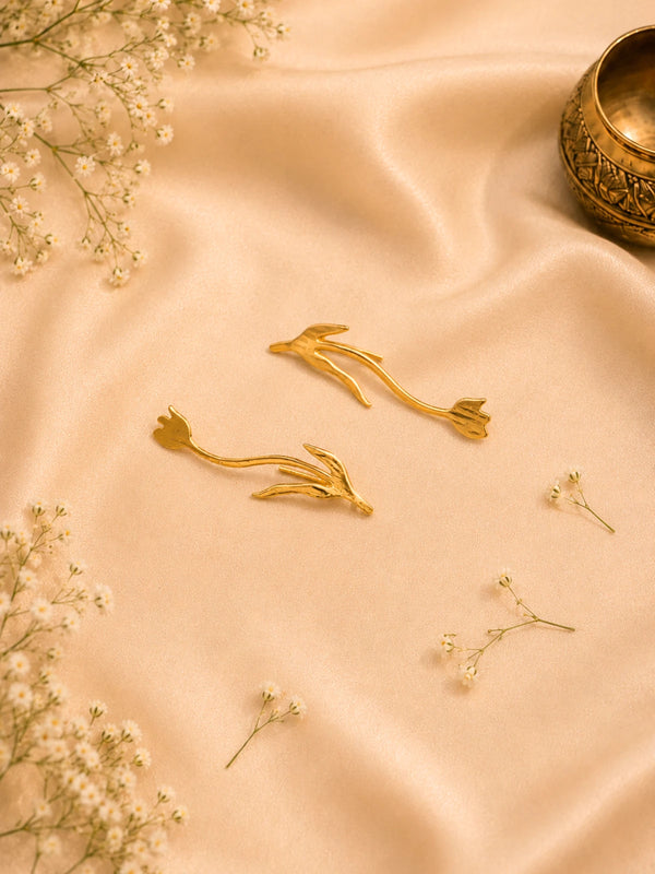 Pair of handmade brass earrings, each shaped as a slender bird in flight with a forked tail, in polished natural brass.